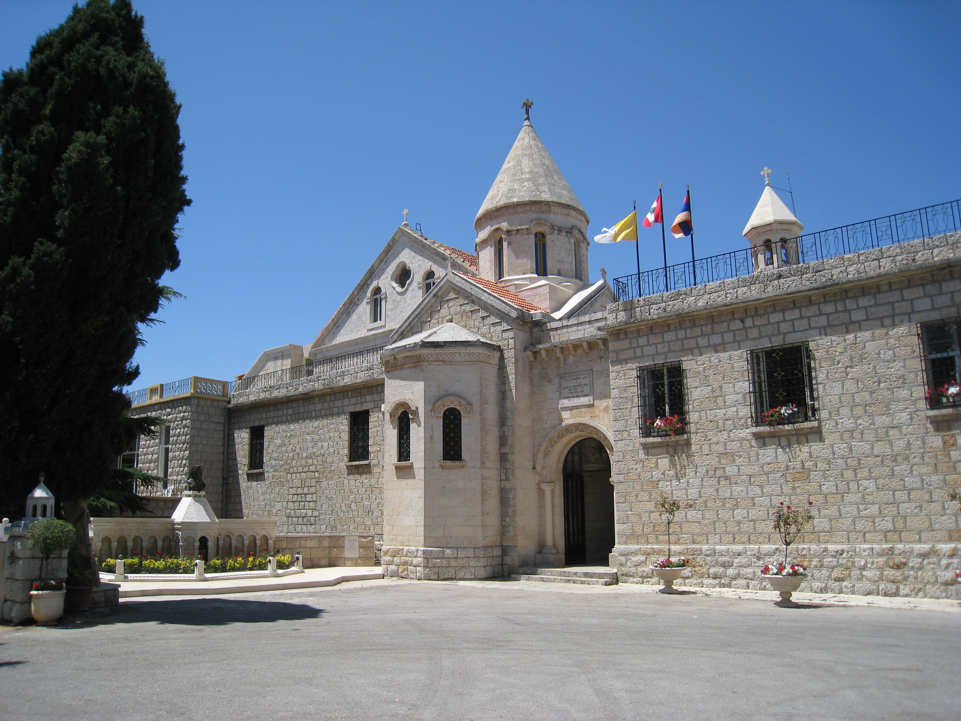 The building of the Armenian Catholic Patriarchate in Bzommar, Lebanon, flying the flags of the Vatican, Lebanon, and Armenia
